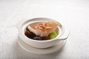 steamed fresh cod grouper fish fillet with vegetable, herb and black bean soy sauce in white background asian halal seafood fine dining menu