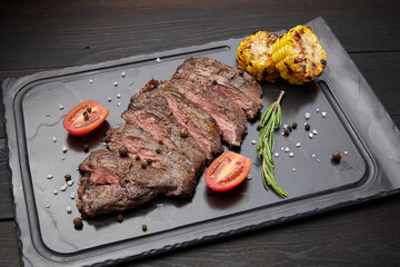 Fried steak lies on a dark background