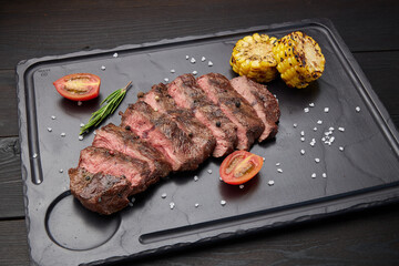 Fried steak lies on a dark background