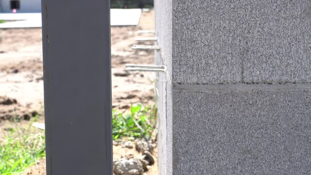 Close up of a brick wall while it is under construction.