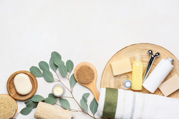 Composition with bath supplies and branch on light background
