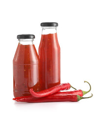 Bottles of chili sauce on white background
