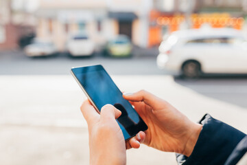 Woman holding mobile phone in her hands