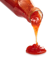 Bottle with spilled chili sauce on white background