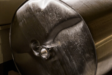 Extruded and deformed casing of a stainless steel tank.