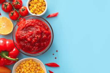Bowl of tasty salsa sauce with products on color background