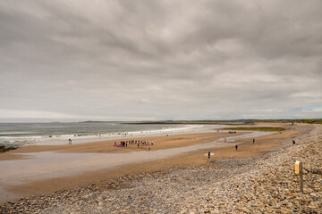 Strandhill beach, county Sligo, Ireland, Surfing training on the sand by the ocean. Dramatic cloudy...