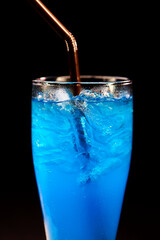 closeup glass of blue hawaii isolated on black