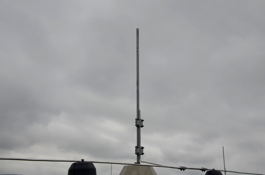A lightning conductor is used to protect buildings from lightning that can damage a house or its electrical equipment is routed to the highest points of a green garden roof.