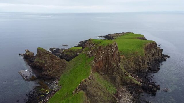 Descending drone shot of sea cliff in Scottish Highlands - Brother's Point, Isle of Skye