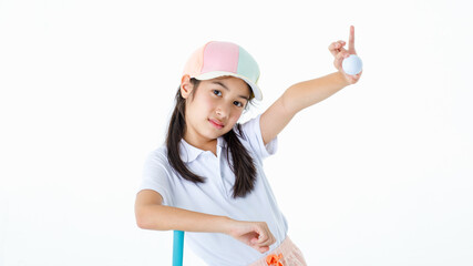 Portrait close up isolated studio shot of Asian little professional girl golfer in sport cloth uniform kneel on green grass holding golf club putter and show ball in hands in front white background