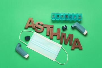 Inhalers, pills, medical mask and word ASTHMA on color background