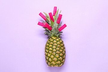 Fresh pineapple with curlers on color background