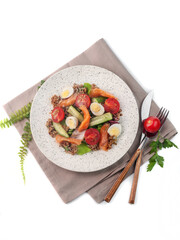 salad of quinoa, fresh vegetables, salmon, garnished with quail eggs top view on white background closeup. Selective focus