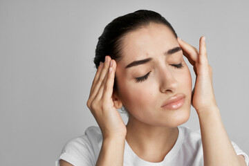 woman with headache dissatisfaction health problems medicine light background