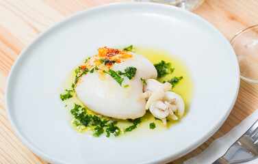 Dish of Mediterranean cuisine - roasted cuttlefish green sauce and parsley