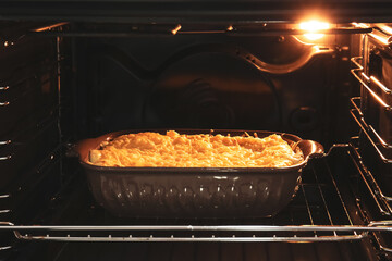 Baking of tasty green lasagna in oven