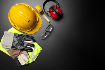Work safety. Construction site protective equipment on wooden background, flat lay, copy space, top view