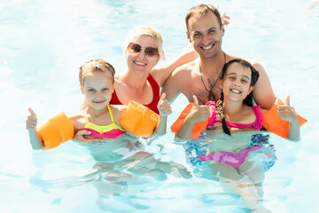 family at the pool on summer vacation.