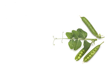 Pods of green peas with leaves isolated on white background