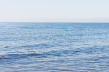 Naklejka na ściany i meble Deep blue and rough sea with lot of sea spray.Blue background.Soft focus,blurred image.