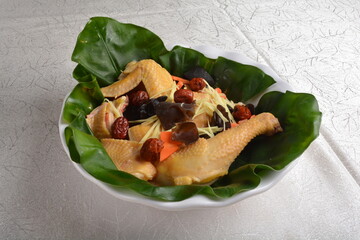 braised stew whole fresh chicken meat with chinese fungus herbal wine sauce wrapped in lotus leaf asian halal menu