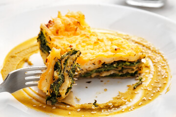 Plate with tasty green lasagna, closeup