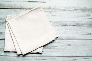 Fabric napkins on color wooden background