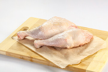 Raw chicken leg over background
