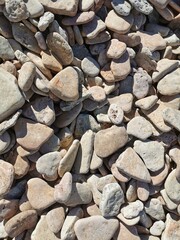 small pebbles on the shore of the lake stony background