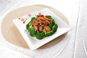 wok stir fried slices meat duck, pork, beef, chicken in soy sauce with broccoli vegetable asian halal menu