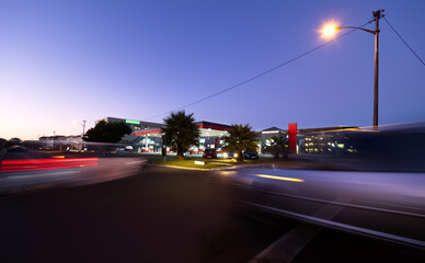 Long exposure, twilight image of the morning traffic at a service station / gas station.