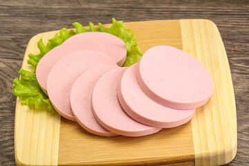 Sliced sausage snak over board © Andrei Starostin