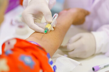 Nurse collecting a blood from patient in hospital