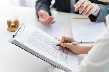 Lawyer Legal counsel presents to the client a signed contract with gavel and legal law. justice and lawyer Business partnership meeting concept.