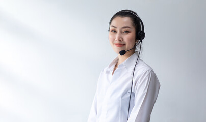 callcenter woman isolated on white background. Portrait Happy Asian woman operator and team working with headsets and desktop computer at telemarketing customer service.