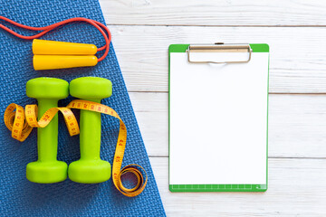 Dumbbells on a wooden background. The concept of a healthy lifestyle.