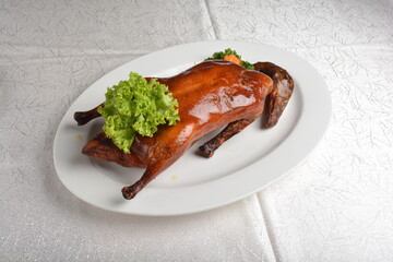 chinese bbq roasted braised whole peking duck meat with slices mango vegetables and herb sauce...