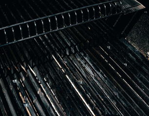 Obraz premium Empty BBQ charcoal black grill or barbeque with black iron grate for cooking outdoor meal.