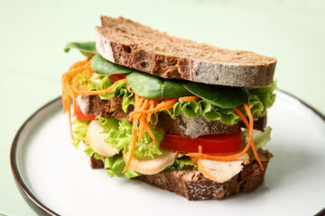 Plate with tasty sandwich on color background, closeup