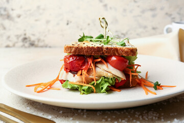 Plate with tasty sandwich on light background, closeup