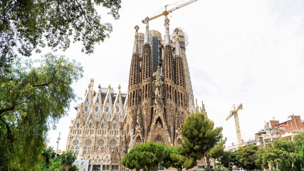 The Sagrada Familia, greenery and construction works in Barcelona