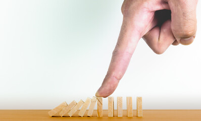 Hand holding domino effect of business crisis or risk protection concept. Business and corporate...