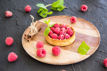 A healthy tasty dessert of cheese raspberry tart. Creative atmospheric decoration