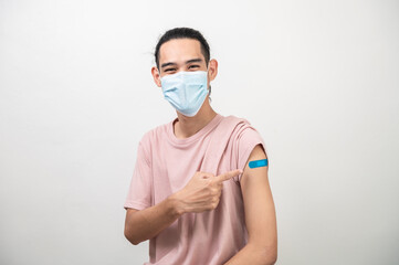 Portrait photo young attractive confident asian man wearing face mask point at bandage receive covid-19 antivirus vaccine safe life protect virus infection. People healthcare social issue concept.