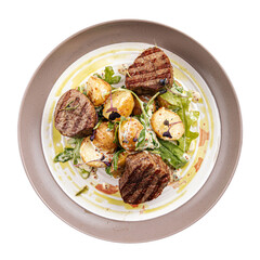 Isolated plate of gourmet fillet mignon steaks with potatoes