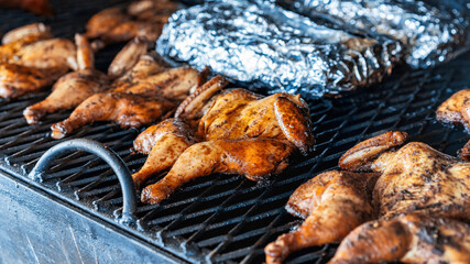 Frying chickens on a grill. BBQ. Street Food