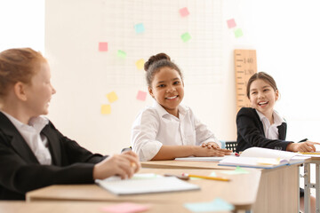 Cute little pupils during lesson at school