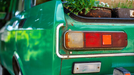 A vintage green car's rear light