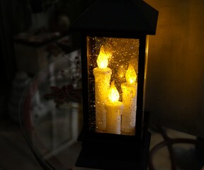 Artificial candles flickering inside a lantern